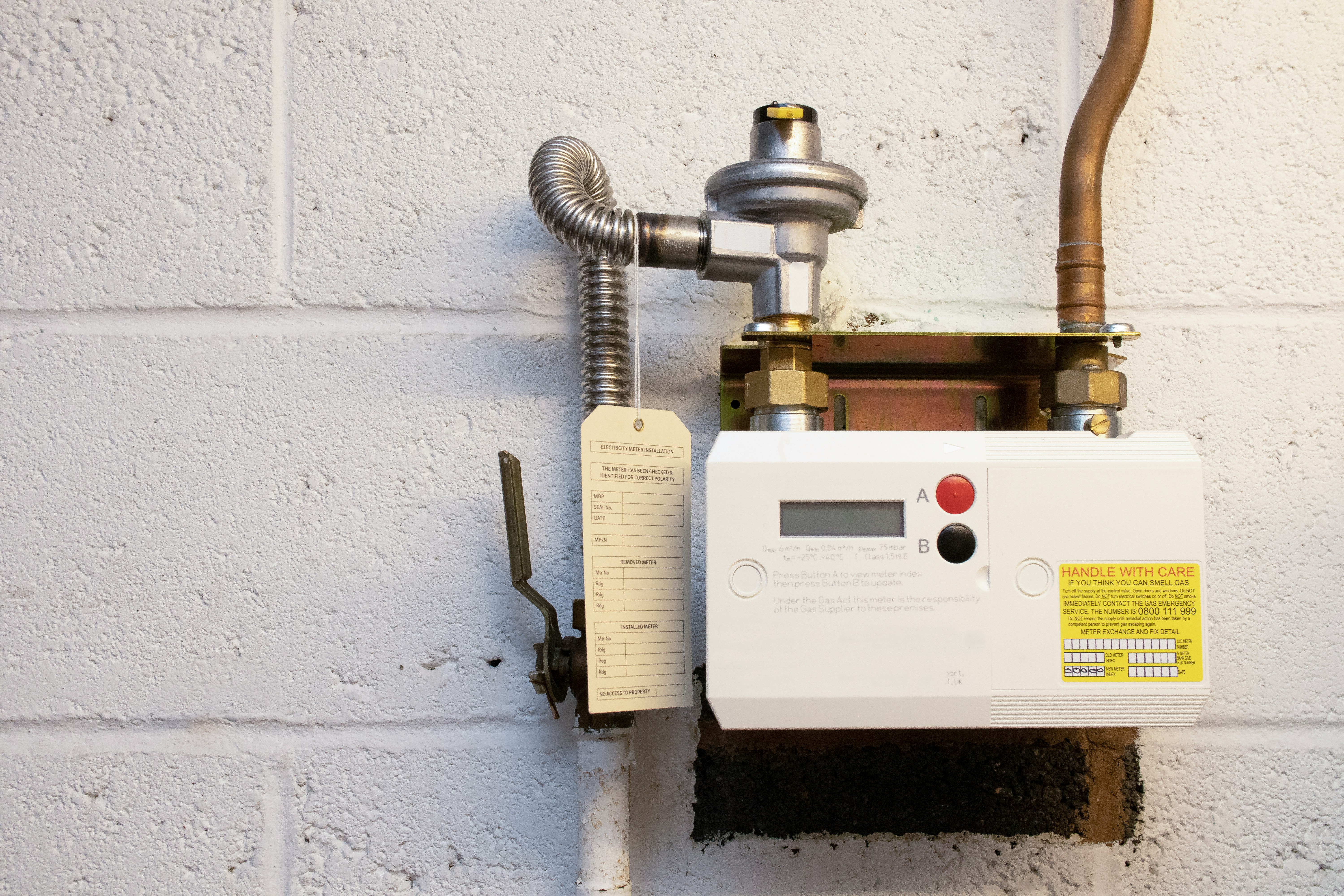 After: new gas regulator, meter and copper pipework with the inspection tag attached