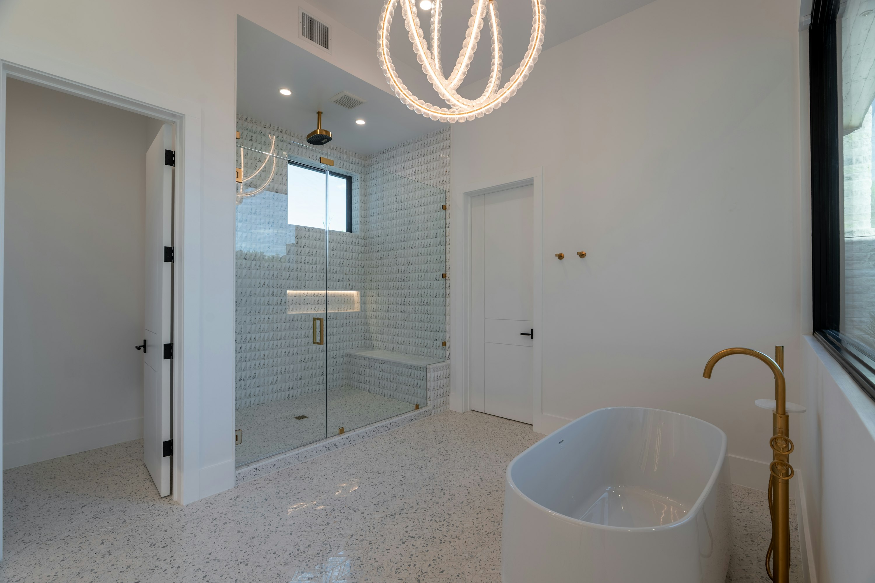 After: finished walk-in shower and freestanding tub in the top-floor apartment