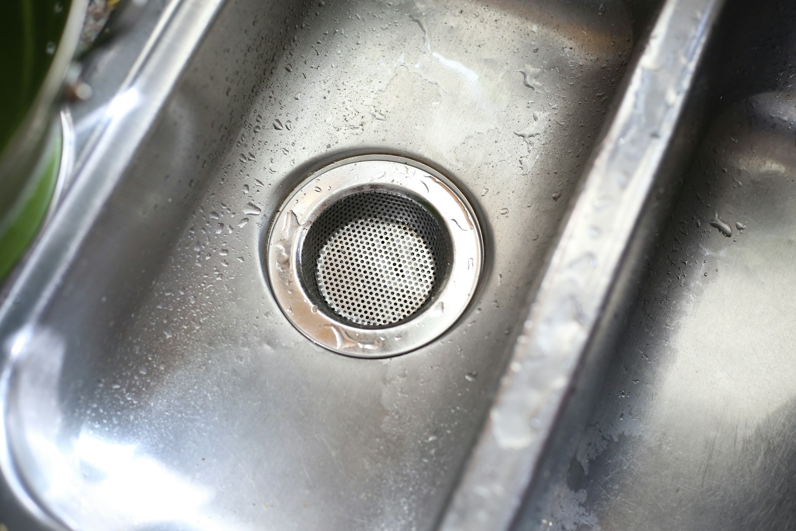 Close-up of a stainless steel kitchen sink drain