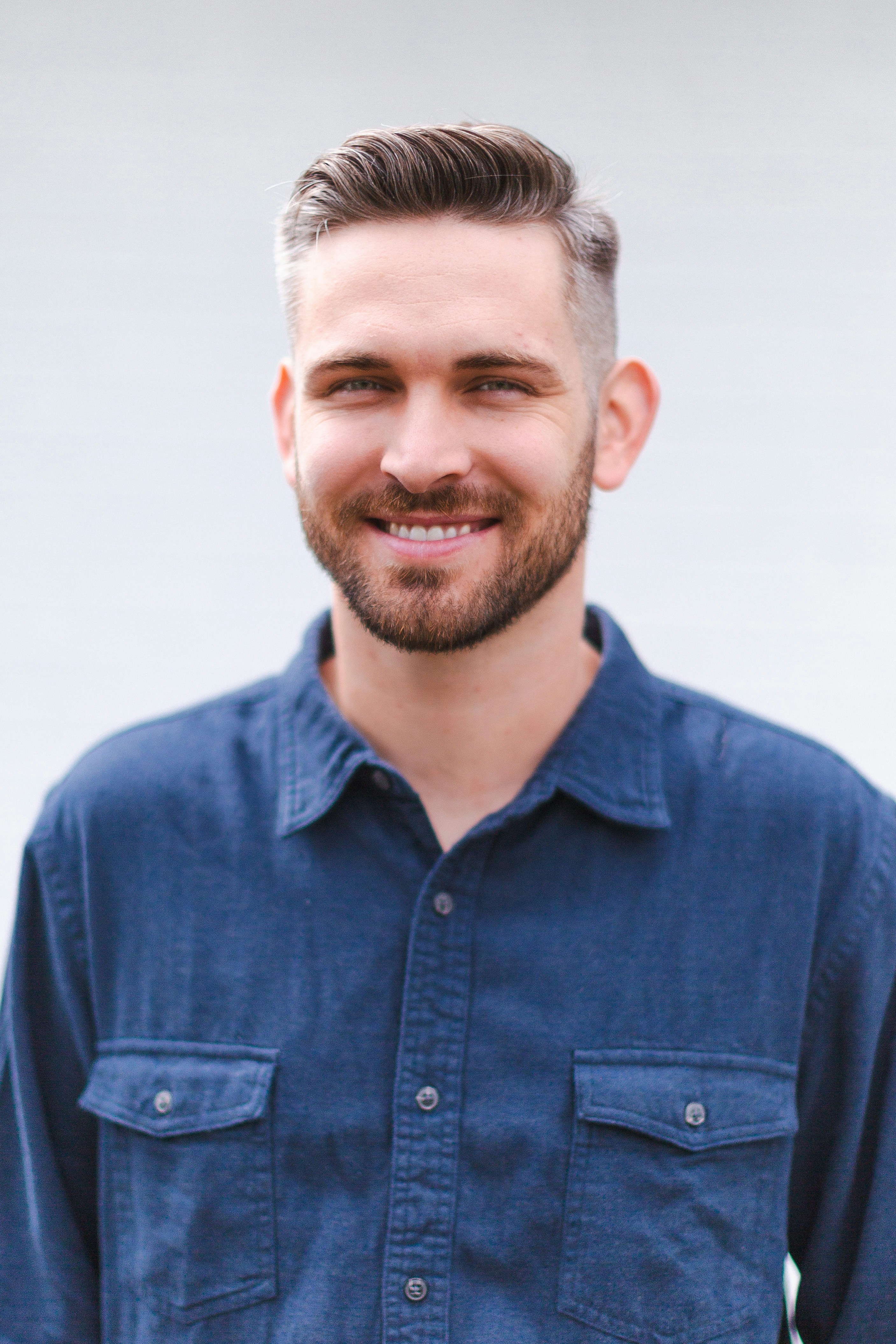 Alex Riddle, licensed electrician, in a blue work shirt