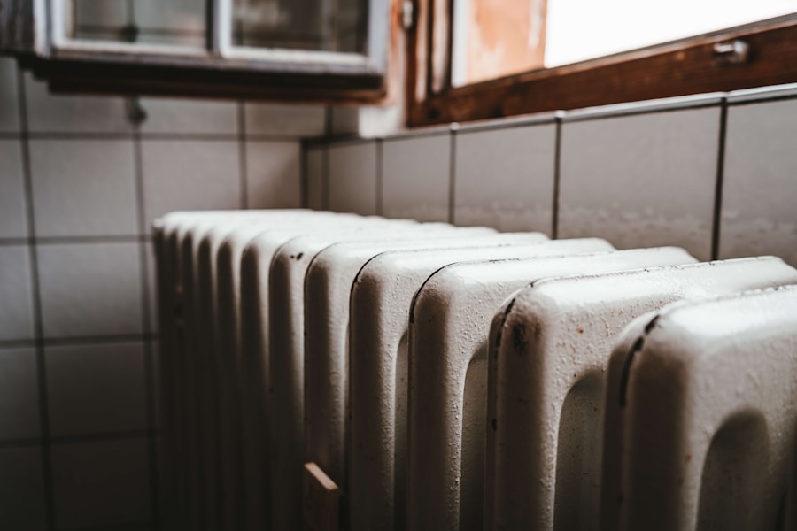 Before: old cast-iron column radiator under a Jackson Heights pre-war window