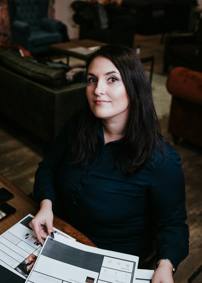 Eva Newman, who writes the quotes and invoices, working through paperwork at the office